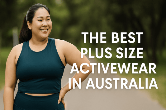 Plus-size Asian woman smiling in dark teal activewear while standing confidently on a path outdoors, with text overlay reading “The Best Plus Size Activewear in Australia.