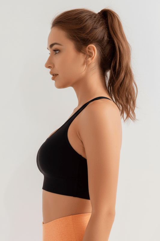 Black Xtreme Sports Bra – Seamless, Open-Back Fit shown from the side, ideal for confident workouts.