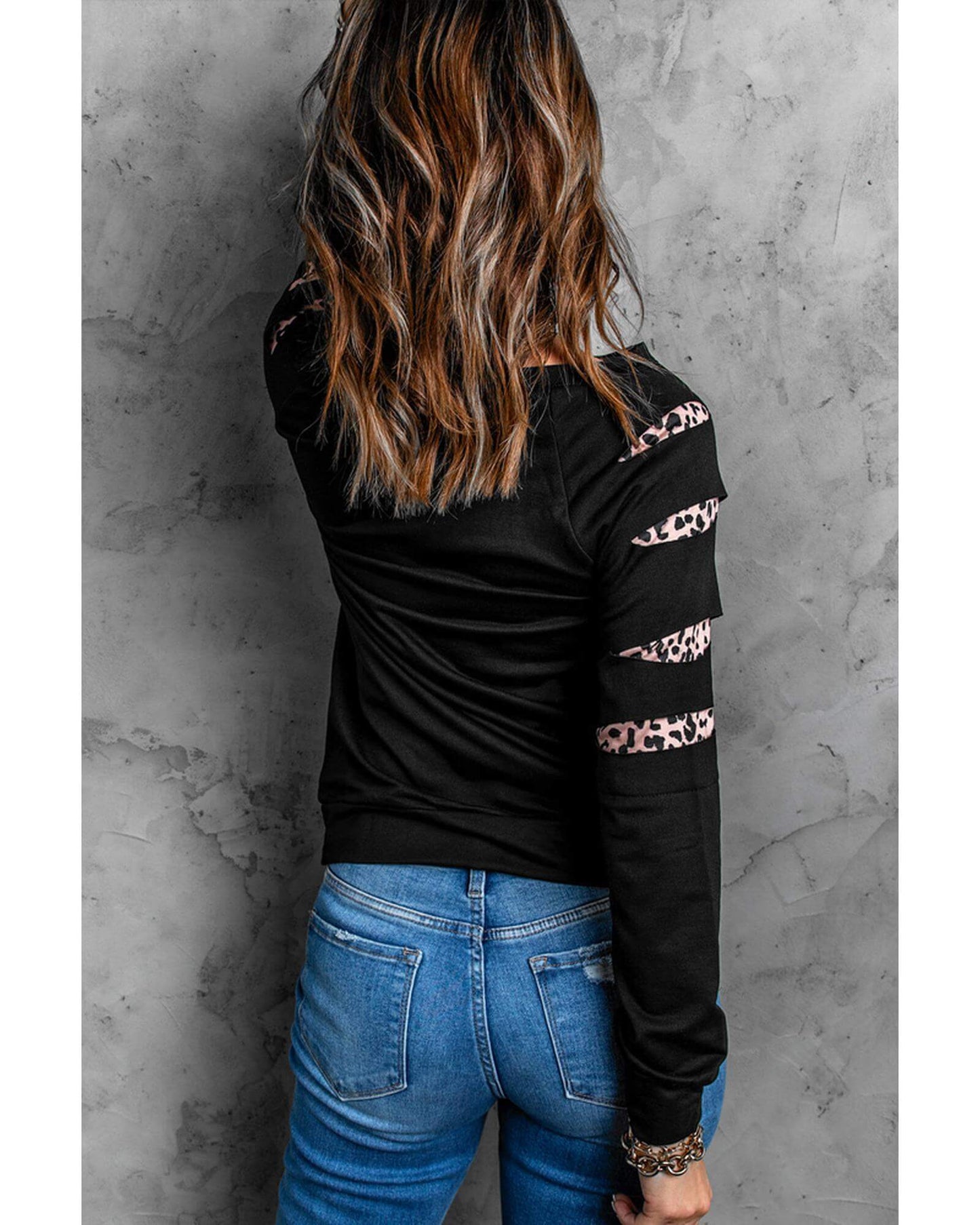Back view of a woman wearing Azura Exchange Black Sweatshirt with stylish leopard insert details, ideal for activewear.