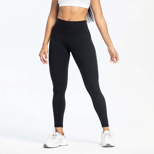 Black Slim-Fit Yoga Pants – High-Waisted with Pockets worn by a model, ideal for training and everyday wear.