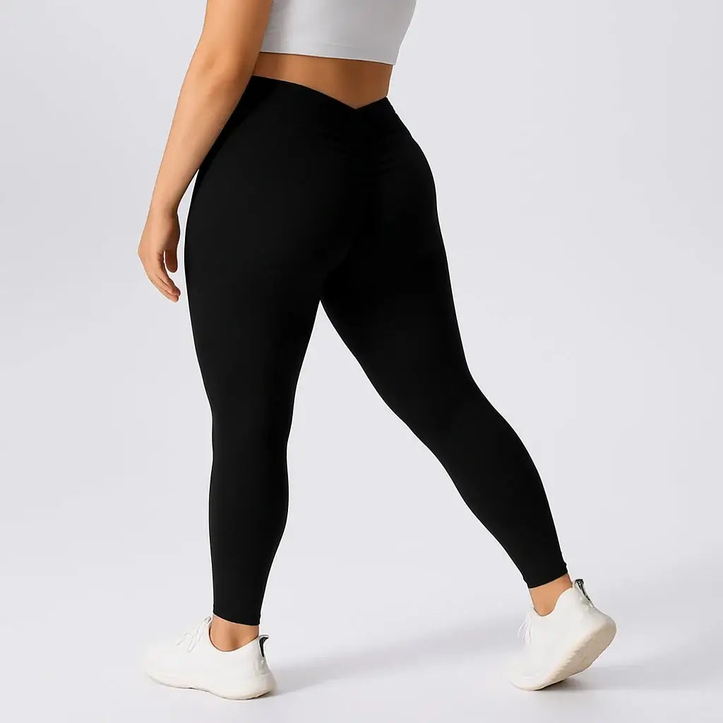 Plus size Woman wearing black lift yoga leggings, showcasing a flattering fit and stylish design for activewear.