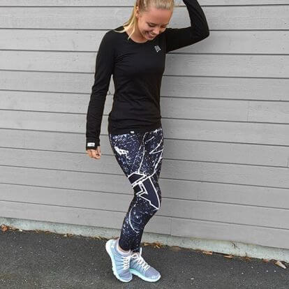 Woman wearing Geometric Print Hip Lifting Stretch High Waist Leggings with a black long-sleeve top and stylish sneakers.