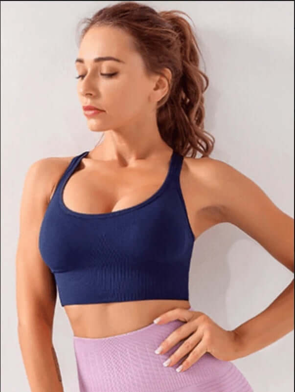 Black Xtreme Sports Bra – Seamless, Open-Back Fit in navy with model showcasing flexibility and style.