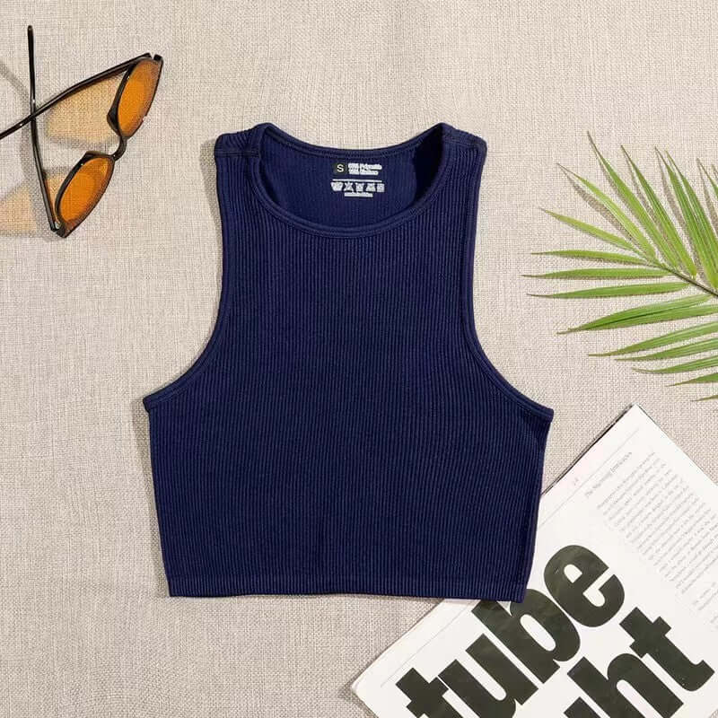 Black Sleeveless Sports Vest – Quick-Dry, Lightweight Fit laid flat with sunglasses and a plant on a table.