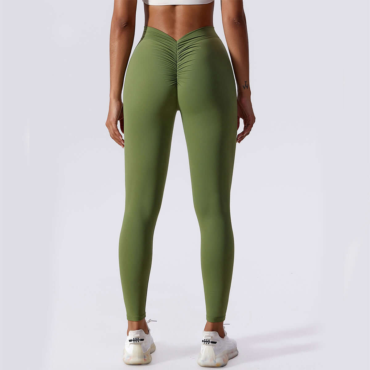 Back view of women's olive green Peach Lift Yoga Leggings, featuring a flattering ruched design and slim fit for activewear.