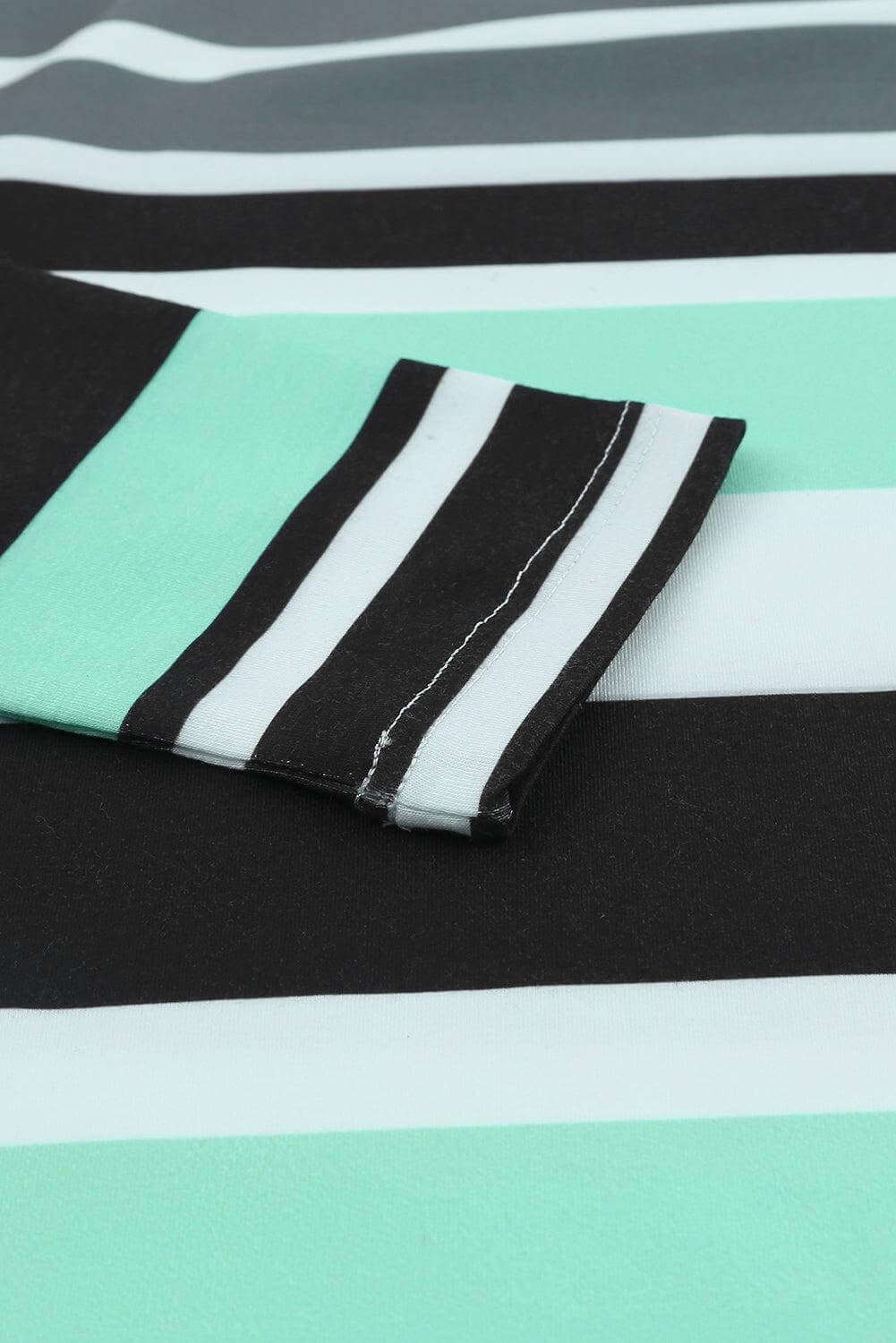 Close-up of the Azura Exchange Striped Hoodie sleeve, showcasing the stylish black, mint, and white stripes. Women's casual wear.