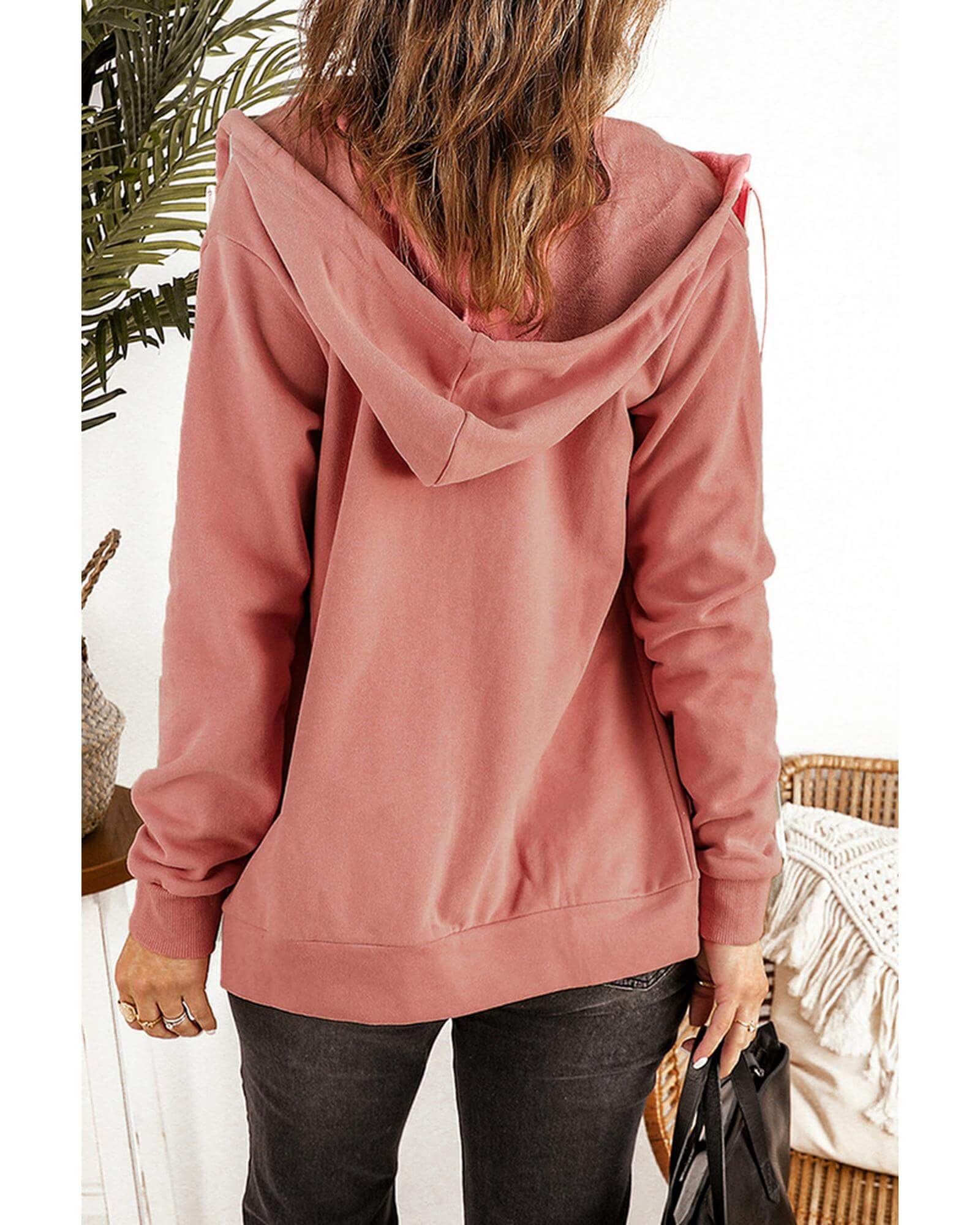 Back view of a pink women's zip-up hoodie jacket, perfect for casual style and comfort.