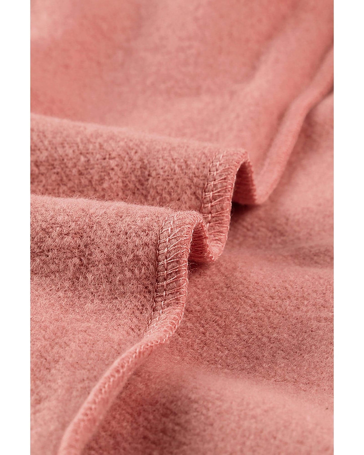 Close-up of the soft pink fabric of a women's casual hoodie, showcasing its cozy texture.