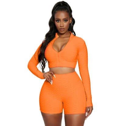 Women's Tracksuit Yoga Fitness Activewear Set in vibrant orange with long sleeves and shorts, perfect for workouts.