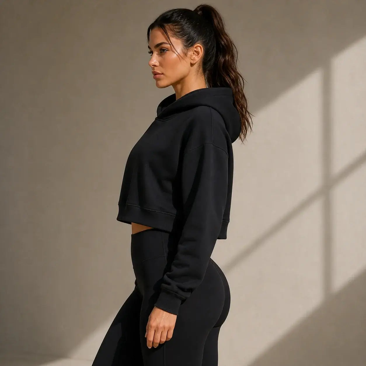 Layna Cropped Layer Hoodie in black, showcasing a stylish cropped fit ideal for activewear.